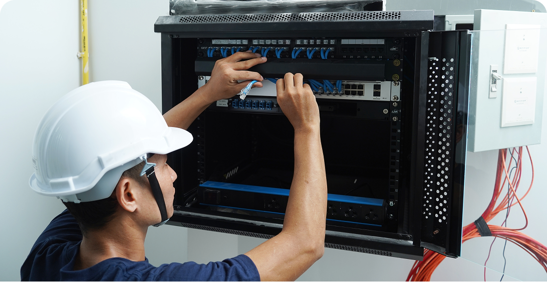 Engineer adjusting server cables
